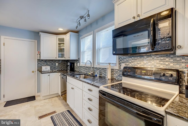 kitchen with white cabinetry, sink, dark stone countertops, and black appliances