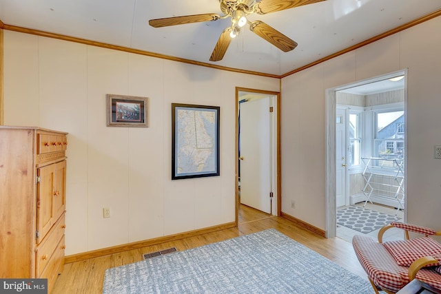 bedroom featuring ornamental molding, ensuite bathroom, and light hardwood / wood-style floors