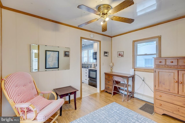 living area with crown molding, sink, ceiling fan, and light hardwood / wood-style flooring