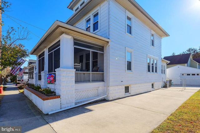 view of side of property with a sunroom