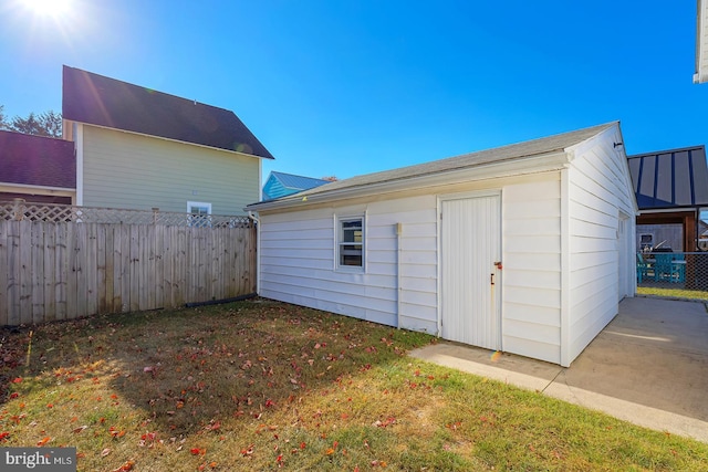 view of outbuilding with a lawn