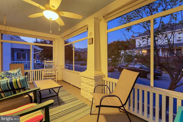 sunroom featuring ceiling fan and radiator heating unit