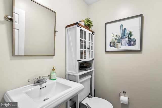 bathroom with toilet and sink