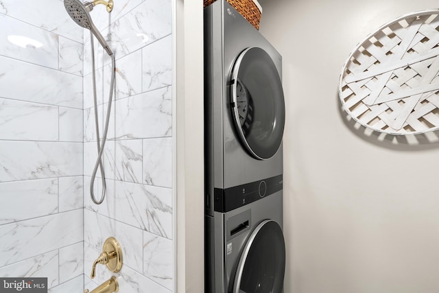 laundry room with stacked washing maching and dryer