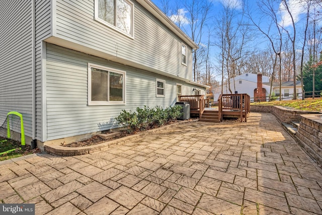 view of patio with a wooden deck and central air condition unit