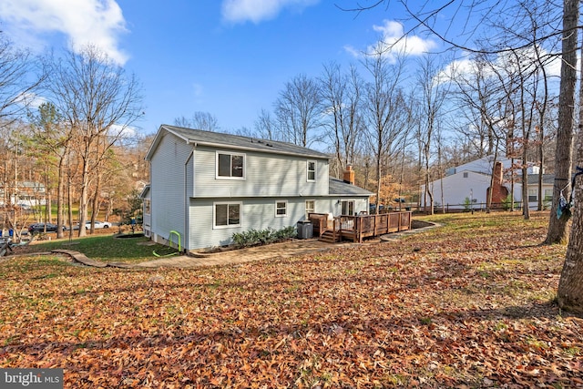 back of property with cooling unit and a deck