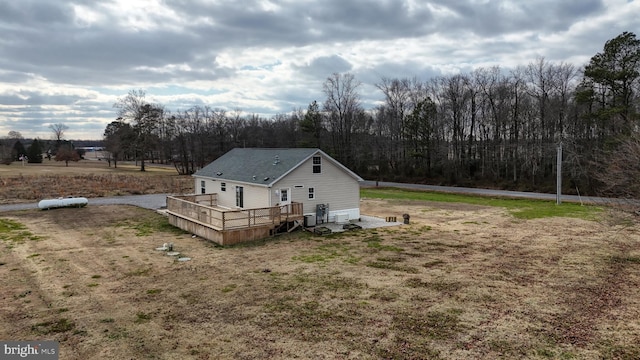 view of home's exterior with a yard and a wooden deck