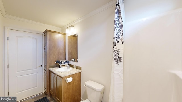 bathroom with vanity, toilet, and ornamental molding