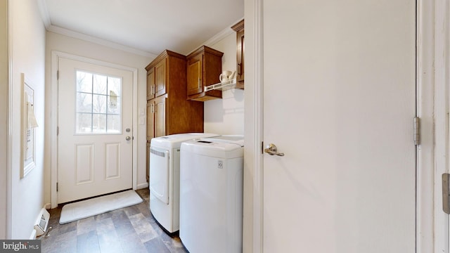 laundry area with washing machine and clothes dryer, dark wood-type flooring, cabinets, and ornamental molding