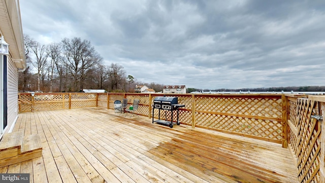 wooden deck with a grill