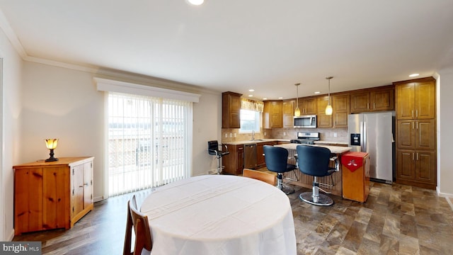 dining area featuring crown molding and sink