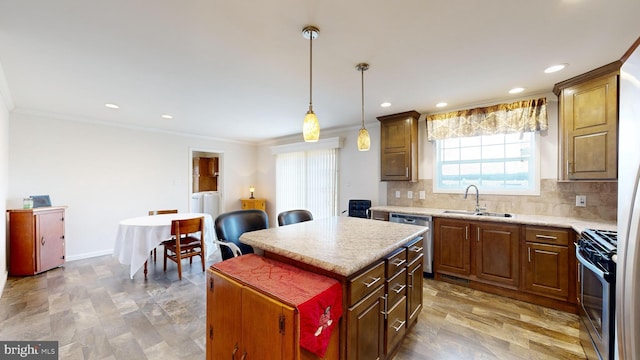 kitchen with decorative backsplash, appliances with stainless steel finishes, sink, a center island, and hanging light fixtures