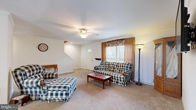 carpeted living room featuring ceiling fan and ornamental molding