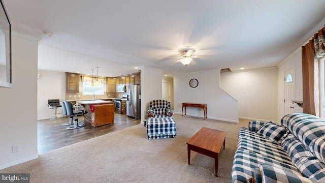 living room with light carpet, ceiling fan, and ornamental molding