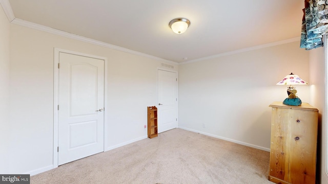 unfurnished bedroom featuring light colored carpet and ornamental molding