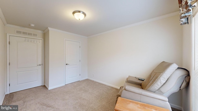 sitting room with ornamental molding and light carpet