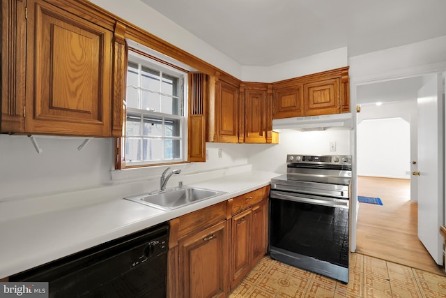 kitchen with stainless steel electric range oven, light wood-type flooring, sink, and black dishwasher