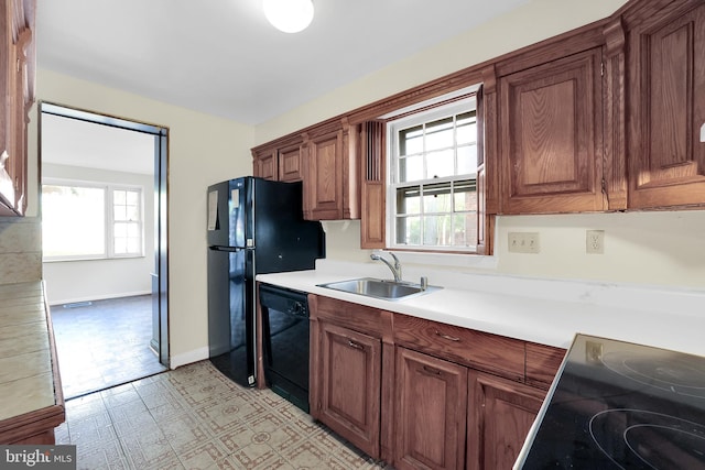 2905 Tilden St NW, Washington, DC 20008 - kitchen with black appliances, a sink, light countertops, light floors, and baseboards