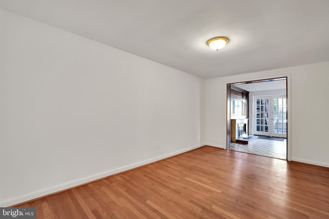 2905 Tilden St NW, Washington, DC 20008 - unfurnished room featuring light wood finished floors, baseboards, and french doors