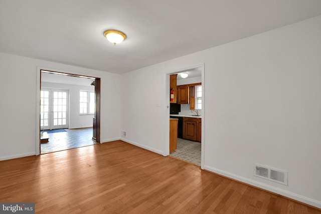 empty room with light hardwood / wood-style flooring