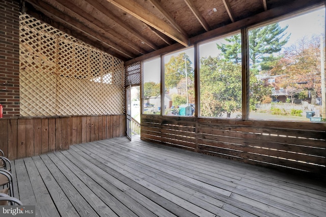 unfurnished sunroom featuring vaulted ceiling