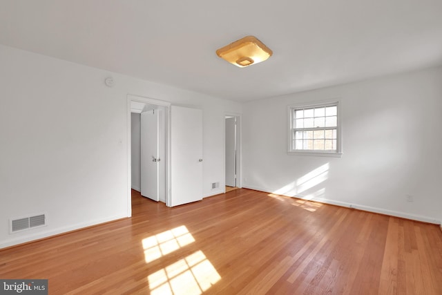 spare room featuring light hardwood / wood-style flooring