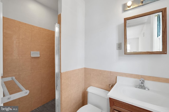 bathroom with walk in shower, tile walls, vanity, and toilet