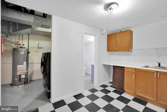 kitchen featuring water heater, sink, washing machine and clothes dryer, and dishwasher