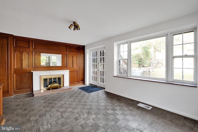 unfurnished living room with dark parquet floors