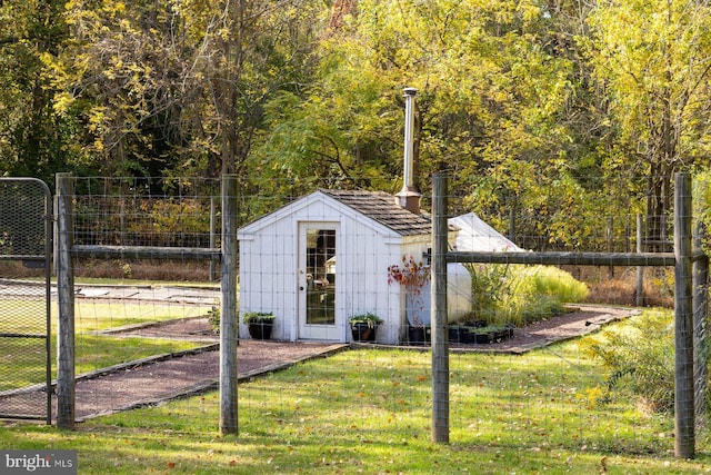 view of outbuilding with a yard