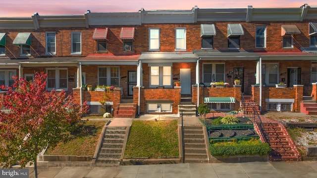 townhome / multi-family property featuring a porch