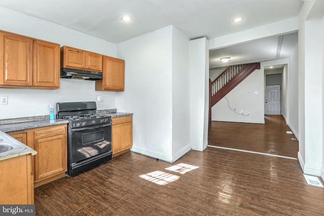 kitchen featuring black gas range and dark hardwood / wood-style flooring