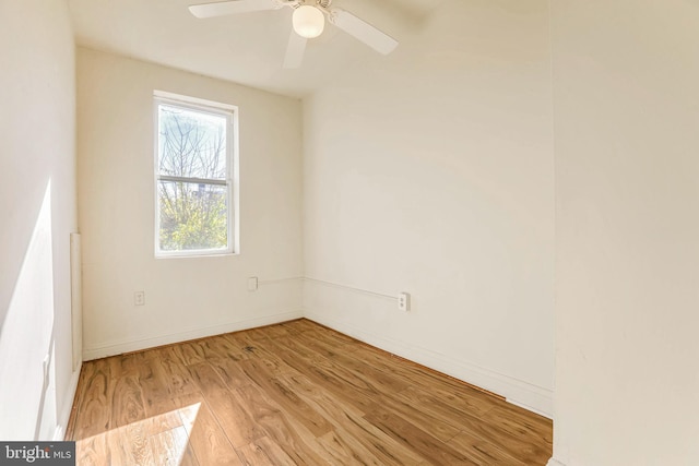 spare room with ceiling fan and light wood-type flooring