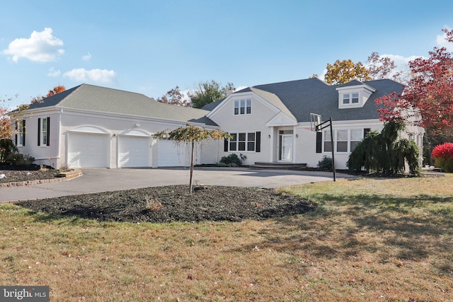 view of front of property with a front yard and a garage