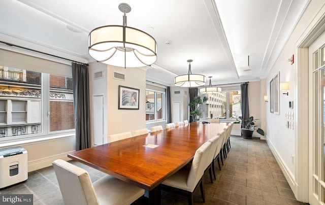 dining area featuring crown molding and a raised ceiling