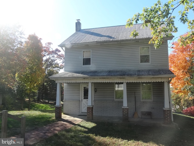 view of front of house with covered porch and a front yard