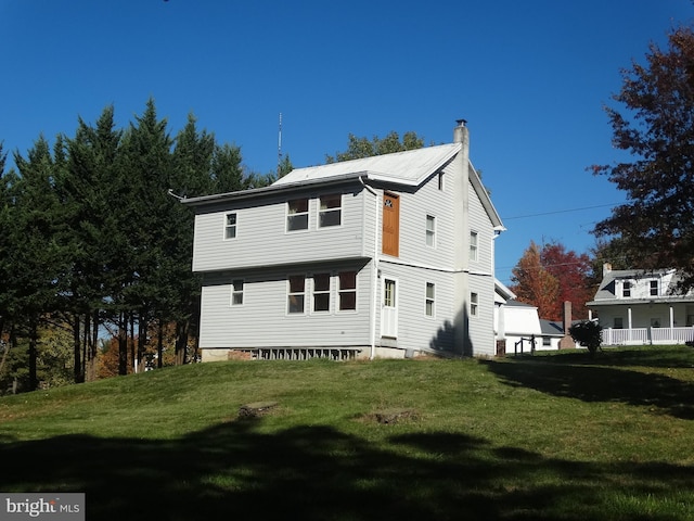 rear view of house with a lawn