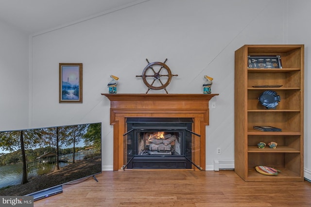 interior details with a baseboard heating unit and hardwood / wood-style floors