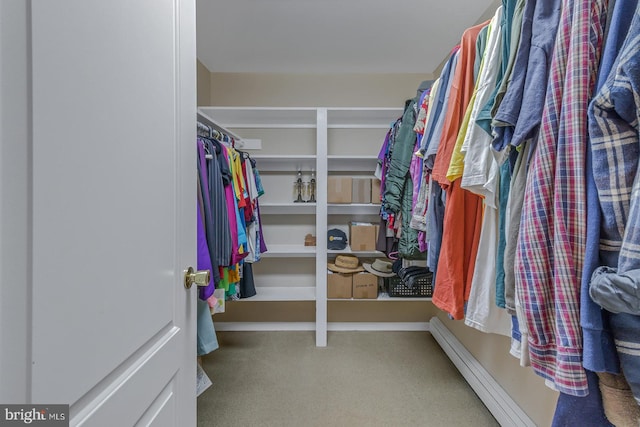 walk in closet with carpet flooring and baseboard heating