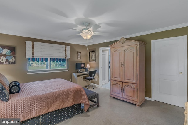 carpeted bedroom with ornamental molding and ceiling fan