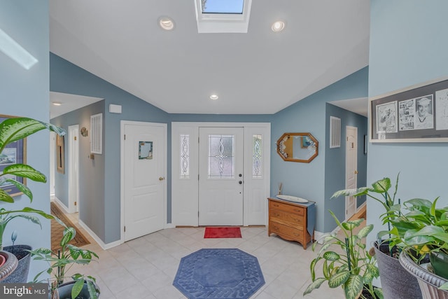 entryway with lofted ceiling with skylight