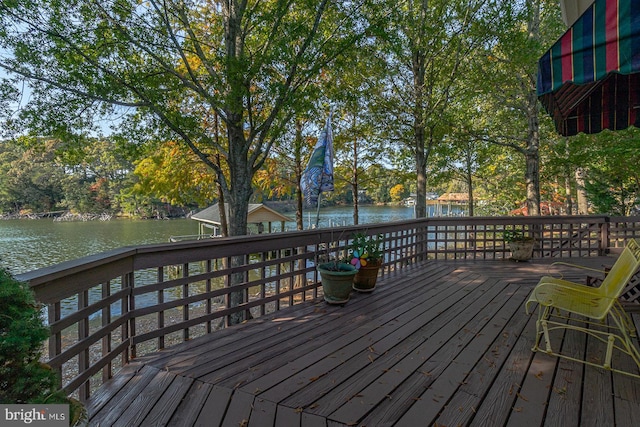 wooden deck featuring a water view