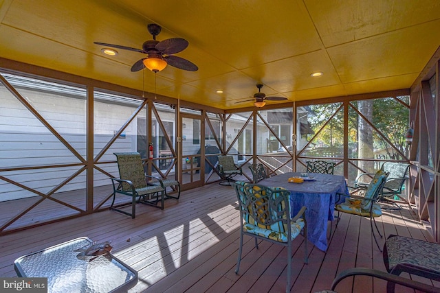 unfurnished sunroom featuring ceiling fan