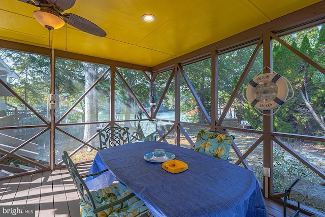 unfurnished sunroom with ceiling fan