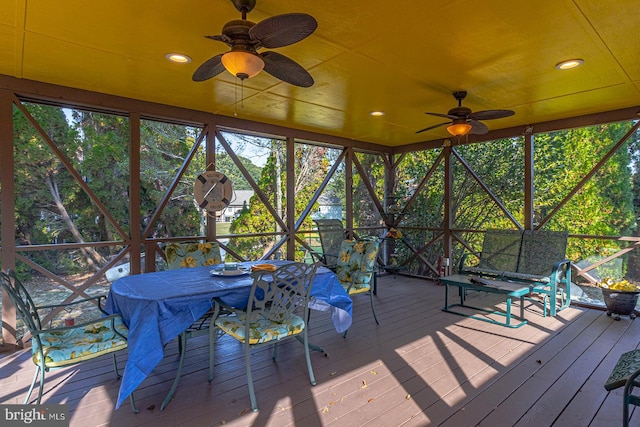 unfurnished sunroom with ceiling fan