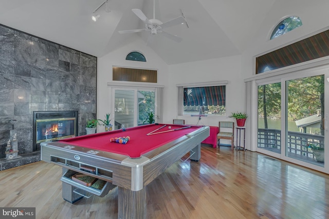 game room featuring a fireplace, pool table, light wood-type flooring, and high vaulted ceiling