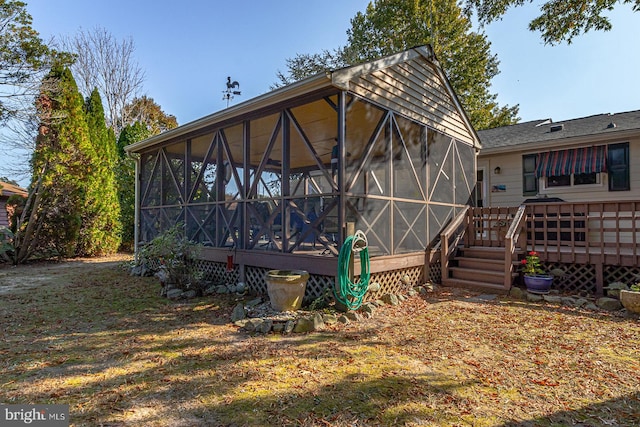 back of house with a deck