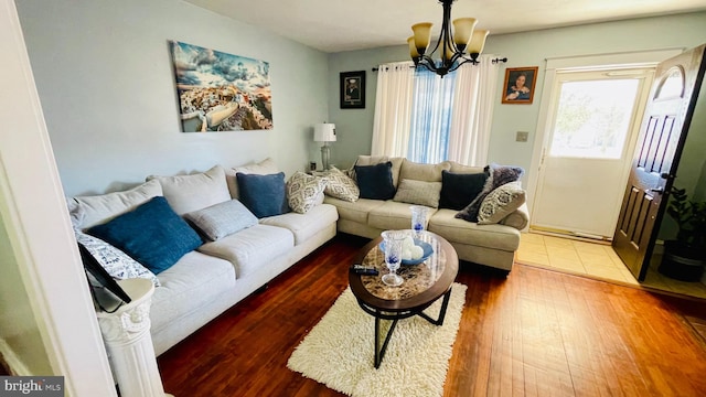 living room with wood-type flooring and an inviting chandelier