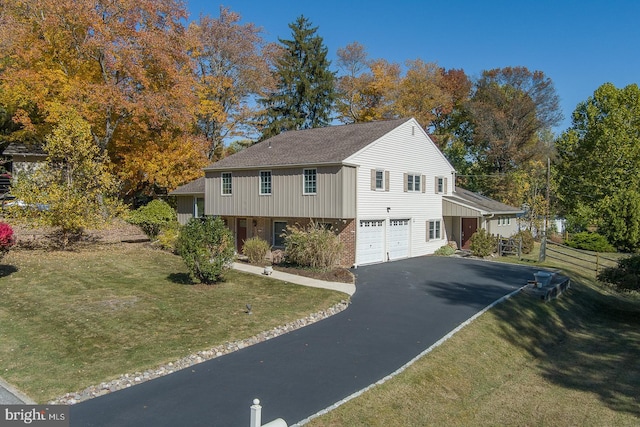 view of front of house featuring a front lawn and a garage