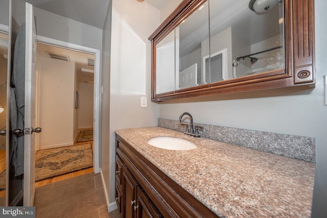 bathroom with vanity and wood-type flooring